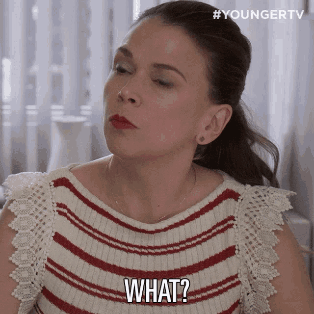 a woman in a red and white striped sweater says " what "