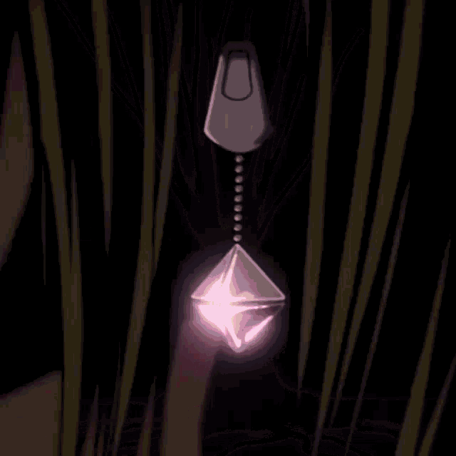 a close up of a necklace with a purple diamond shaped pendant