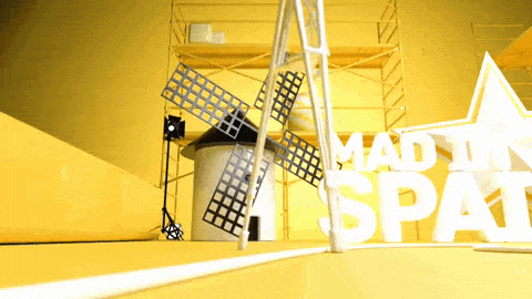 a windmill in front of a sign that says made in spat