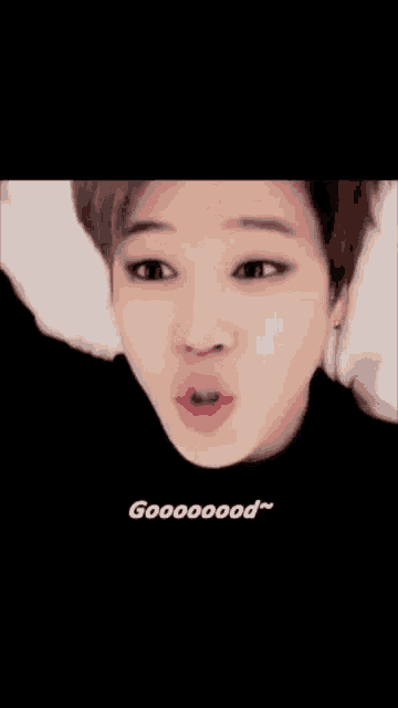a close up of a person laying on a bed with their mouth open and the words gooooood written on the bottom .