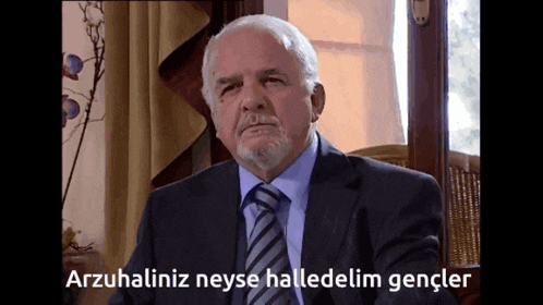 a man in a suit and tie says arzuhaliniz