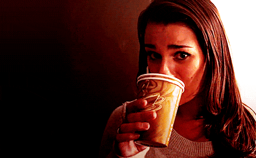 a woman is drinking from a cup that says coffee