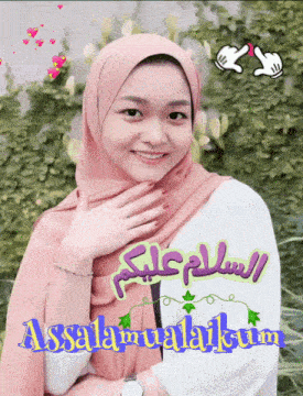 a woman wearing a pink hijab and a white shirt with the words assalamualaikum on the bottom