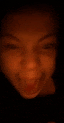 a close up of a person 's face in the dark with their eyes closed .