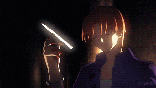 a man in a blue shirt is holding a light in his hand with el-caderos written below him