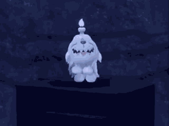 a white stuffed animal with a candle on its head is sitting on a table .