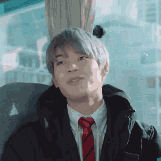 a man in a suit and tie is sitting in a car