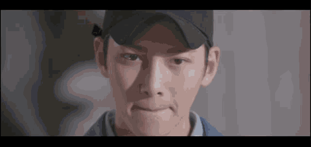 a close up of a man wearing a hat making a funny face