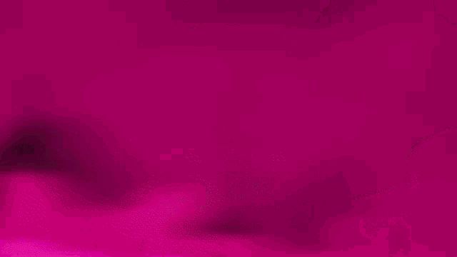 a pink circle with a letter w inside of it on a pink background