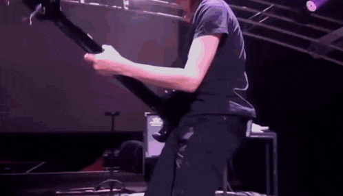 a man is playing an electric guitar on a stage .