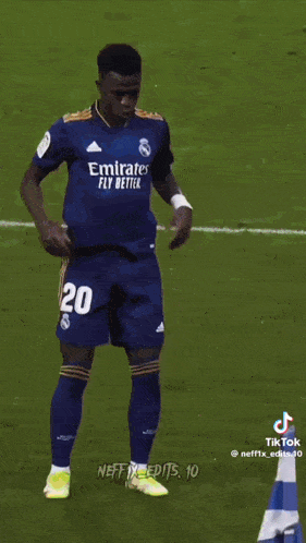 a soccer player is running on the field in front of a stadium full of people .