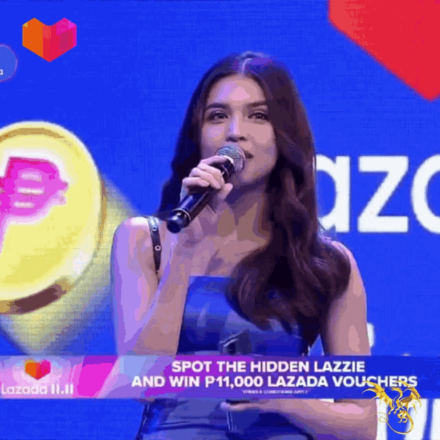 a woman singing into a microphone with a lazada logo in the background