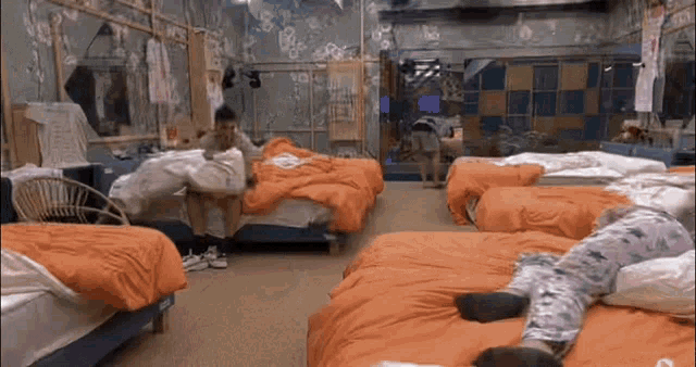 a person laying on a bed in a room with many beds and a sign that says open