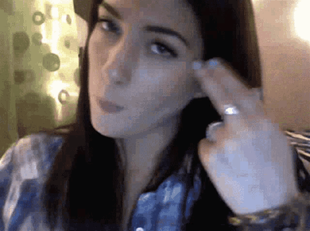 a woman wearing a hat and a ring on her finger