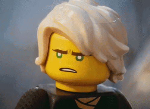 a close up of a lego figure with a serious expression on his face