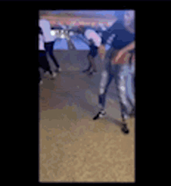 a blurry picture of a group of people standing on a carpet .