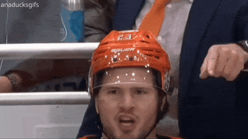 a hockey player wearing a helmet that says bauer on the front
