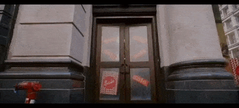 a building with a fire hydrant in front of it and a door with a sign on it that says sale .