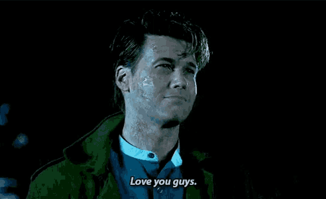 a man with a scar on his face is standing in the dark and says `` love you guys '' .
