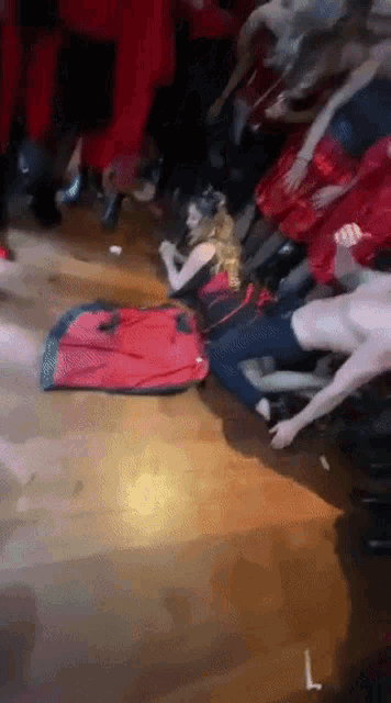 a bunch of people are laying on the floor and one of them has the letter l written on it