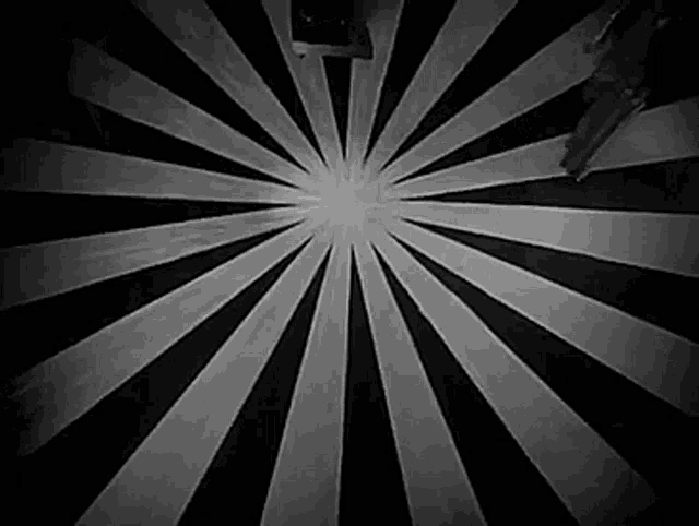 a black and white photo of a circular pattern