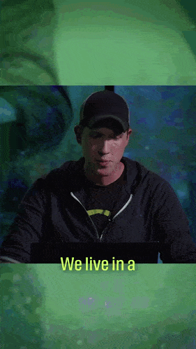 a man sitting in front of a computer with the words we live in a