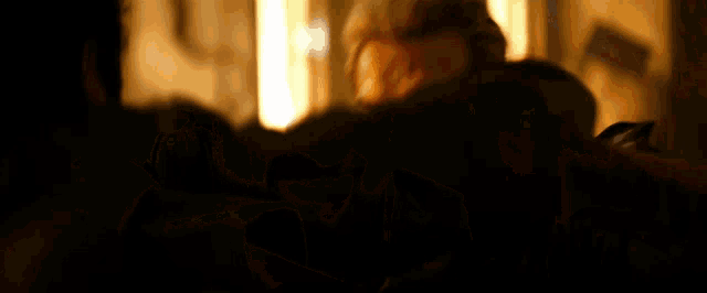 a man 's face is visible in a dark room