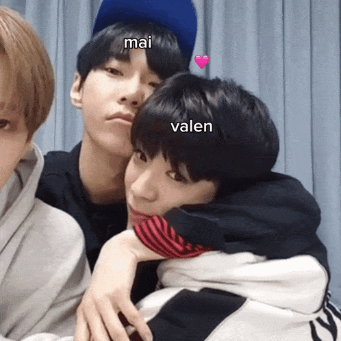 a group of young men are posing for a picture and one of them has the name valen on his head