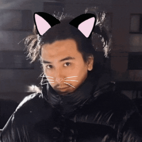 a man wearing a black jacket has a cat ear on his head