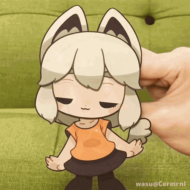 a person is holding a cartoon character with the name wasu @ cermrnl