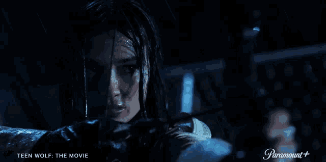 a poster for teen wolf the movie shows a girl holding a bow and arrow in the rain