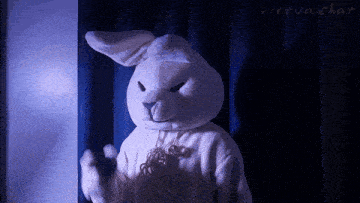 a stuffed bunny is standing in front of a virtual chat sign