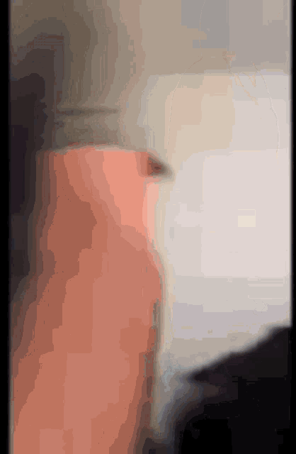 a blurred image of a person 's face with a gray background