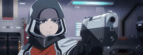 a woman in a helmet is holding a gun in a room .