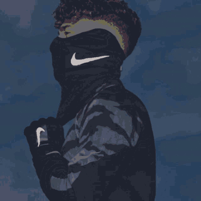 a person wearing a nike scarf around their face