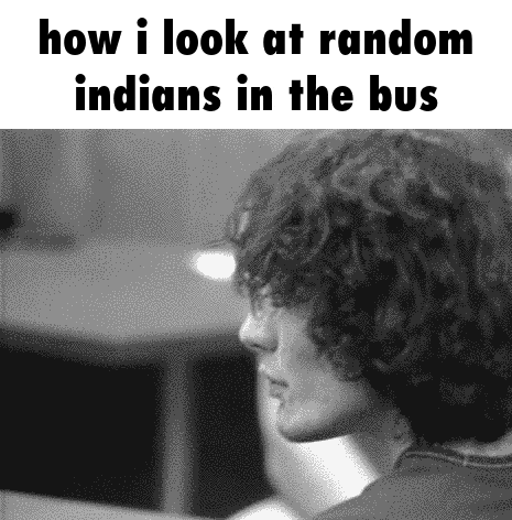 a black and white photo of a man looking at random indians in the bus .