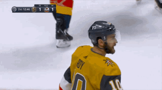 a hockey player wearing a number 10 jersey stands on the ice