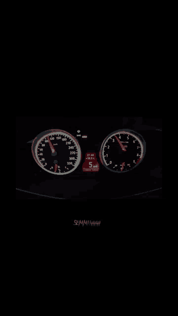 a close up of a car dashboard with a speedometer and a tachometer