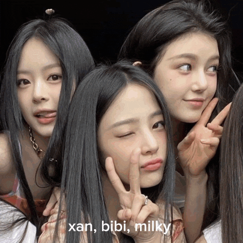 a group of girls are posing for a picture with the words xan bibi milky written above them