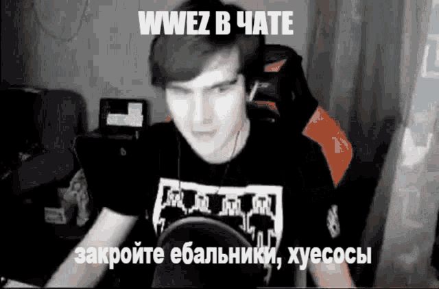 a man wearing headphones is sitting in front of a microphone with the words wwez in chate written above him .