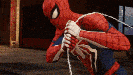 a close up of a spider man holding a rope in his hands