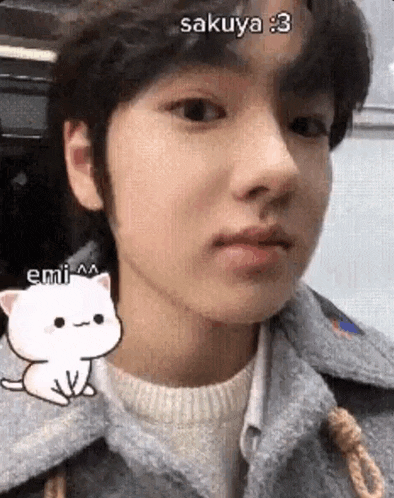 a close up of a person 's face with a cartoon cat next to them .