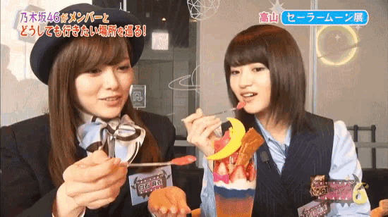 two girls are eating ice cream and one has a sticker that says ' 46 ' on it