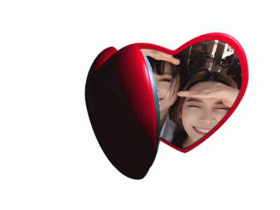 a heart shaped picture frame with two girls making a heart shape with their hands