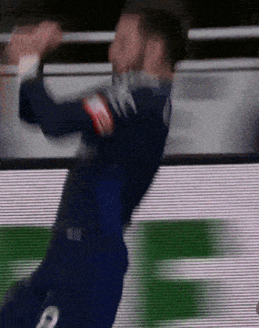 a blurry picture of a soccer player wearing a number 2 jersey