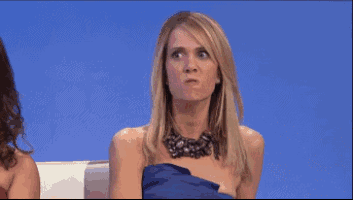 a woman in a blue dress is making a face