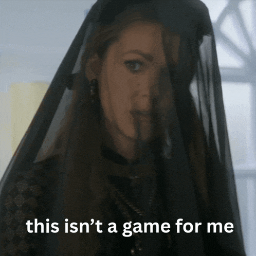 a woman wearing a black veil with the words " this isn 't a game for me " below her
