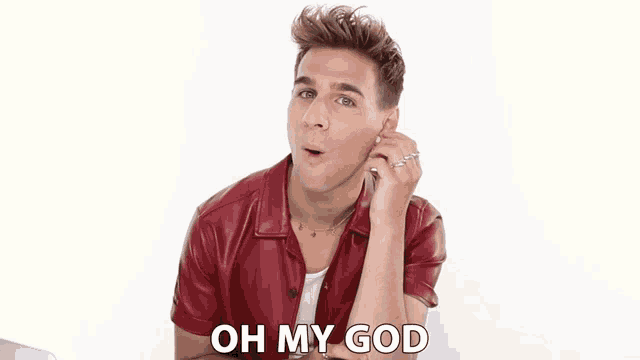 a man in a red shirt is saying " oh my god "