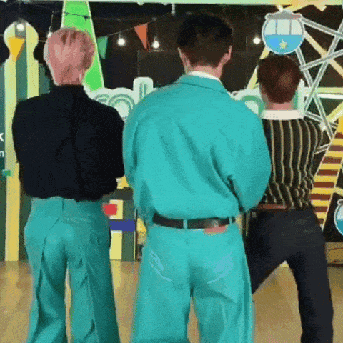 a group of men standing next to each other in a room .