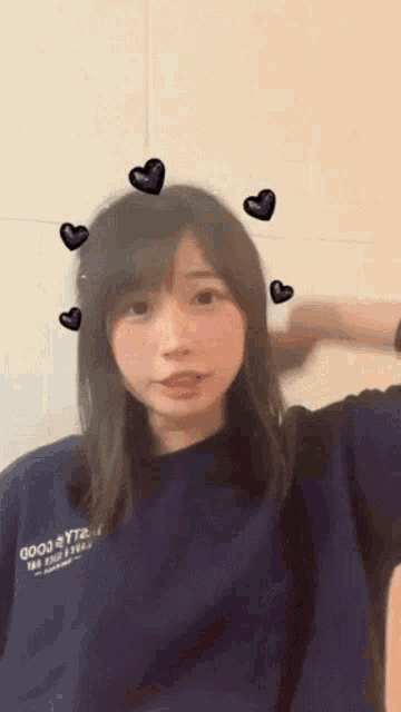 a girl with hearts around her head wearing a shirt that says 2003
